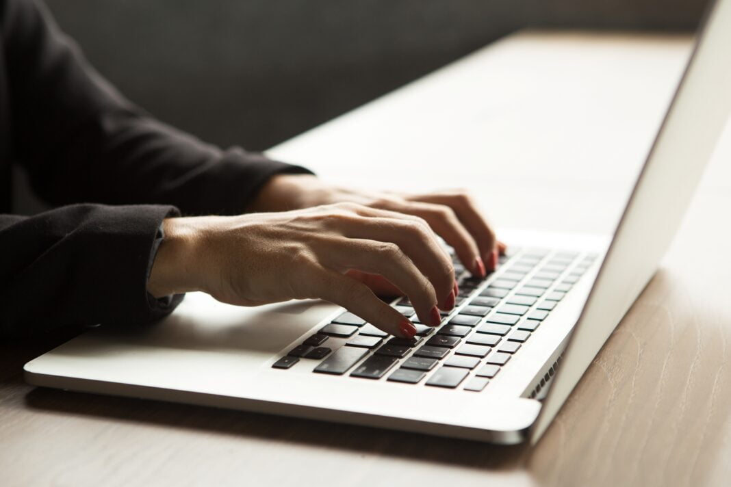 close-up-female-hands-typing-laptop-table